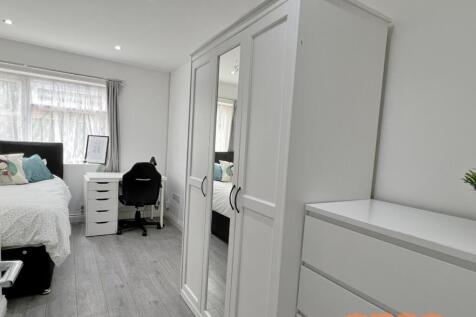 A bright and tidy single bedroom featuring a co...