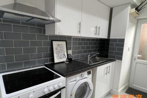 A modern kitchen featuring a sleek black counte...