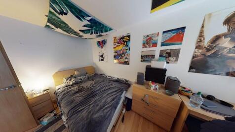 A cozy double bedroom with a comfortable bed, a...