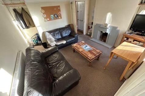 A cozy living room featuring two black leather ...