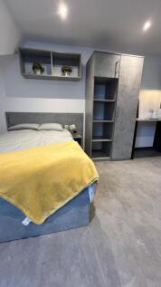 A modern and tidy double bedroom featuring a co...