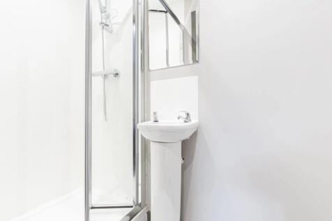 A modern, bright bathroom featuring a clean sho...