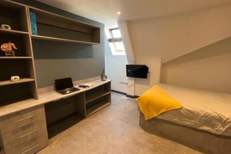 A neat and modern single bedroom featuring a bu...