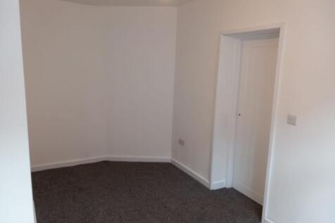 A clean, freshly painted small room featuring a...
