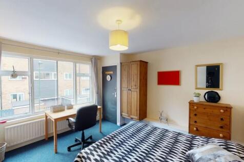 A bright and welcoming double bedroom featuring...