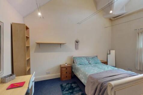 A cozy double bedroom featuring a comfortable d...