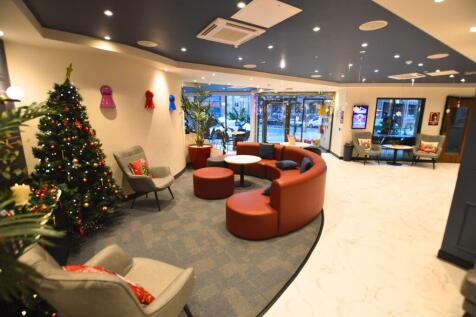 A stylish communal lounge featuring modern curv...