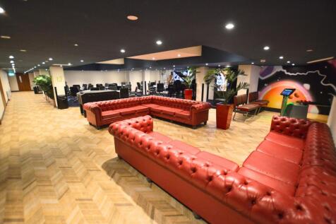 Spacious communal lounge featuring large red le...