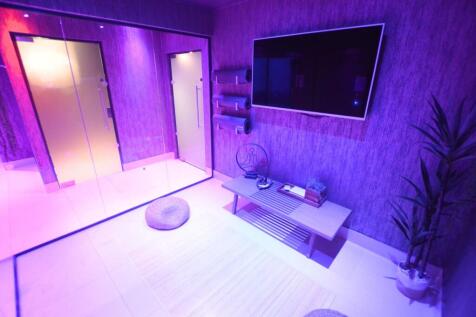 Modern communal lounge with purple ambient ligh...