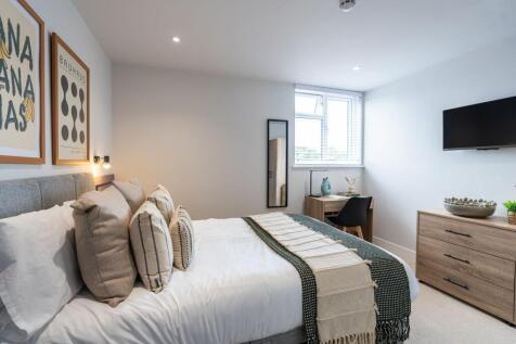A stylish and serene master bedroom featuring a...