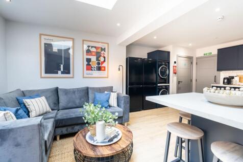 Bright and modern living area featuring a comfo...