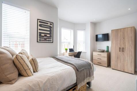 Bright and stylish double bedroom featuring a c...
