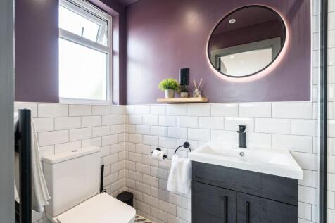 A stylish and modern bathroom featuring a clean...