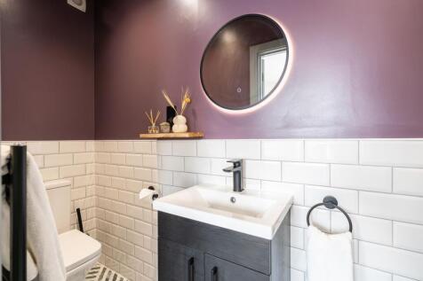 A modern and stylish toilet room featuring a sl...