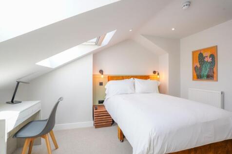 Bright and cozy double bedroom featuring a comf...