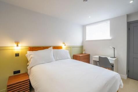 A bright and tidy double bedroom featuring a co...