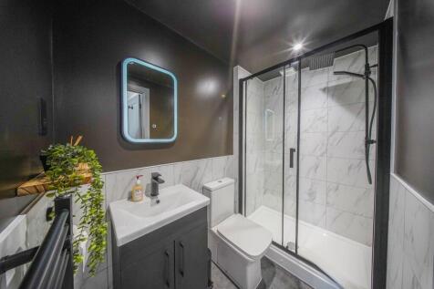 Modern bathroom featuring stylish marble-effect...