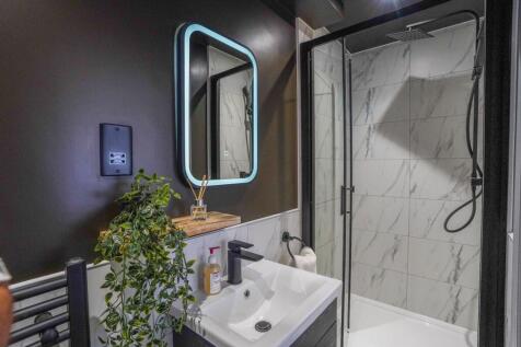Modern bathroom featuring stylish marble-effect...