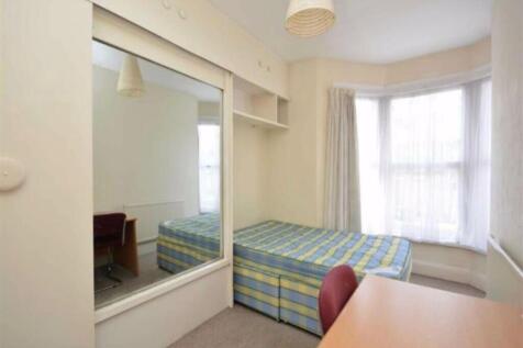 A bright and inviting double bedroom featuring ...