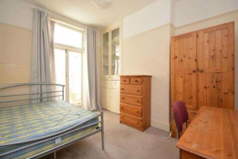 A spacious and well-lit double bedroom featurin...