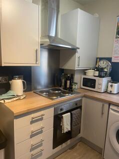 A modern and tidy kitchenette featuring essenti...