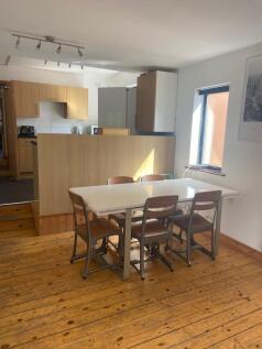 A bright and tidy kitchenette with a dining are...