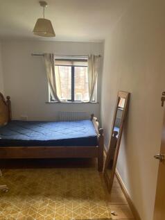 A cozy double bedroom with a bright window and ...