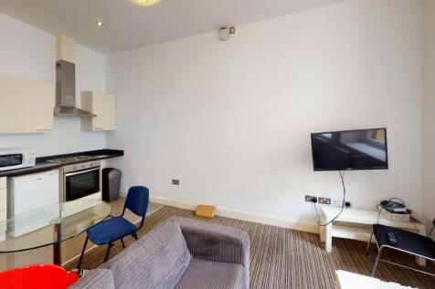 A cozy and modern living room featuring a glass...