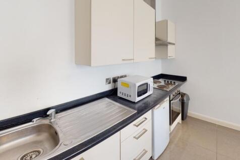 A clean and modern kitchen with ample counter s...