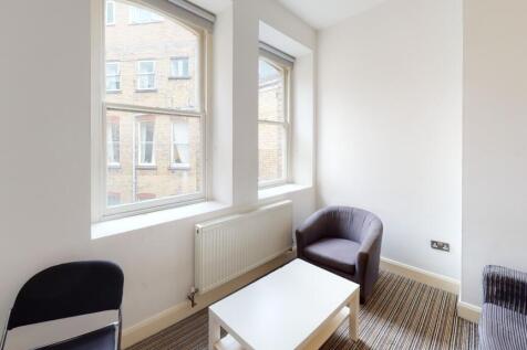A bright and clean communal lounge featuring la...