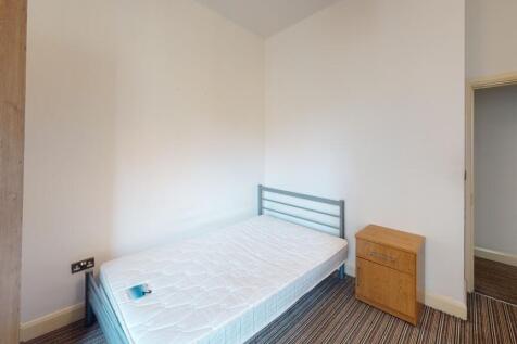 A clean and bright single bedroom featuring a s...