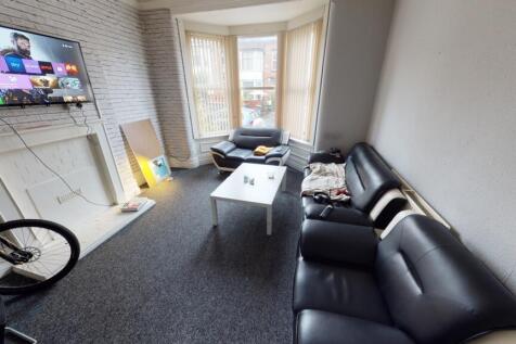 A comfortable living room featuring a large bla...