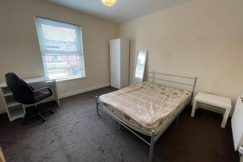 Bright and simple double bedroom featuring a la...