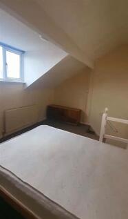 Cozy bedroom with a large window providing natu...