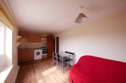 A bright and tidy living space featuring a comp...