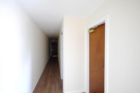 A clean and well-maintained hallway with light-...
