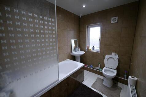 A modern bathroom suite featuring a bathtub wit...