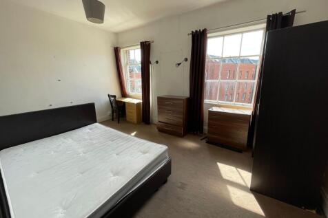 Spacious master bedroom featuring a large doubl...