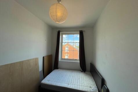 A simple double bedroom featuring a comfortable...