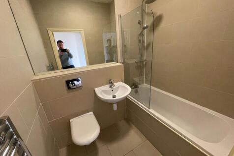 A modern bathroom suite featuring a full-sized ...