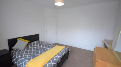 This cozy double bedroom features a comfortable...