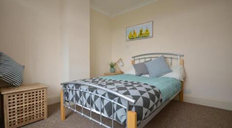 A cozy double bedroom featuring a comfortable b...