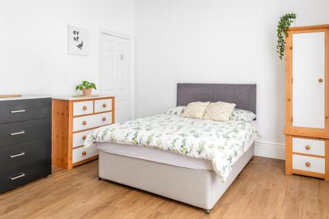 A bright and inviting double bedroom featuring ...