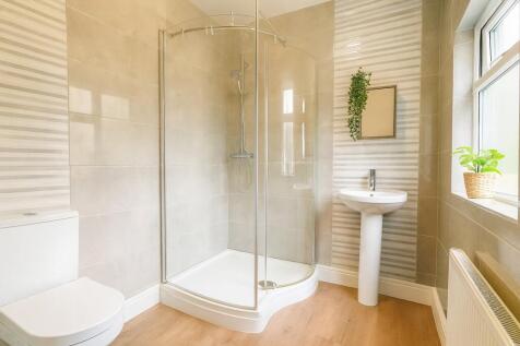 Bright and inviting modern bathroom featuring a...