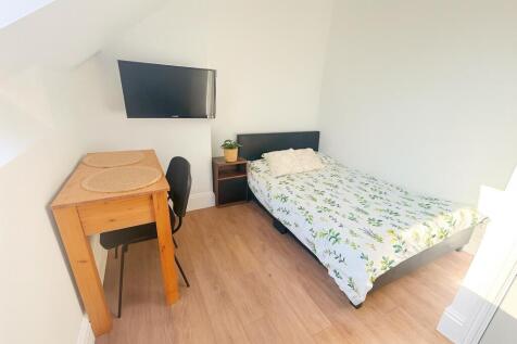 Bright and tidy single bedroom featuring a cozy...