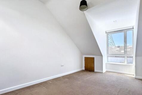 Bright and airy bedroom with a large window pro...