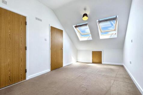 Bright and airy single bedroom featuring two sk...