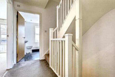 Bright and clean hallway with neutral walls and...