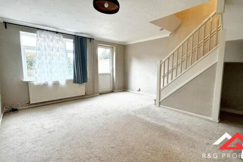 Bright and spacious living room featuring large...