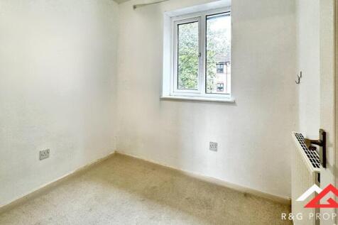A bright, clean single bedroom with a large win...